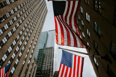 American flags flying between Manhattan skyscrapers