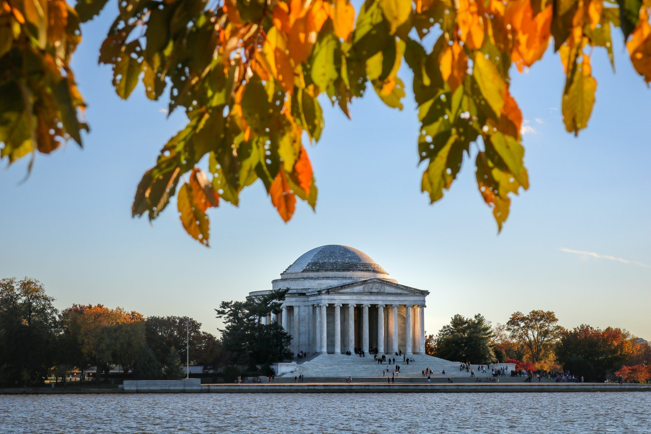 Jefferson Memorial across the Tidal Basin framed by autumn foliage