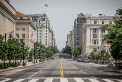 Pennsylvania Avenue wide and empty with federal buildings on both sides