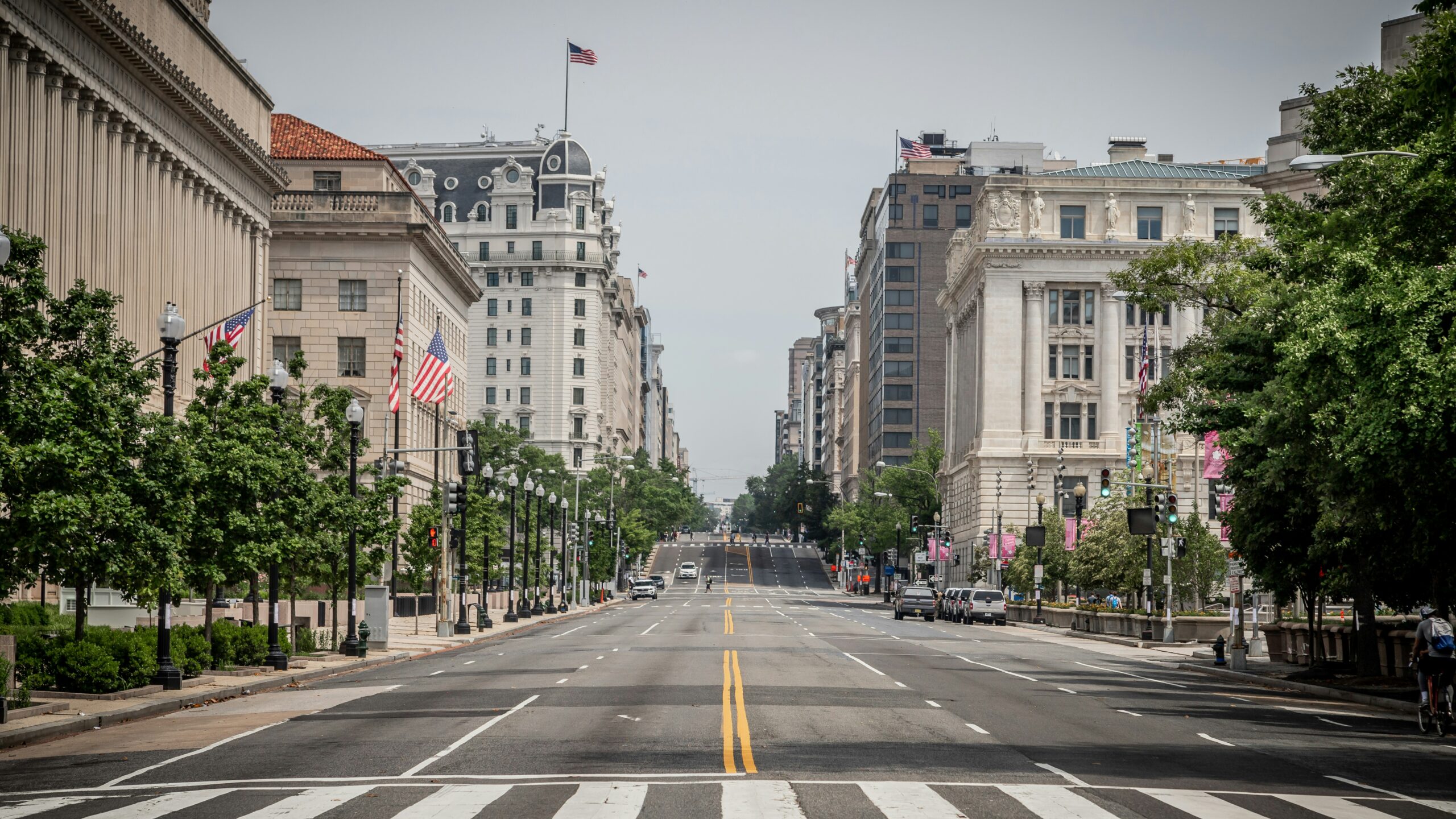 Pennsylvania Avenue wide and empty with federal buildings on both sides