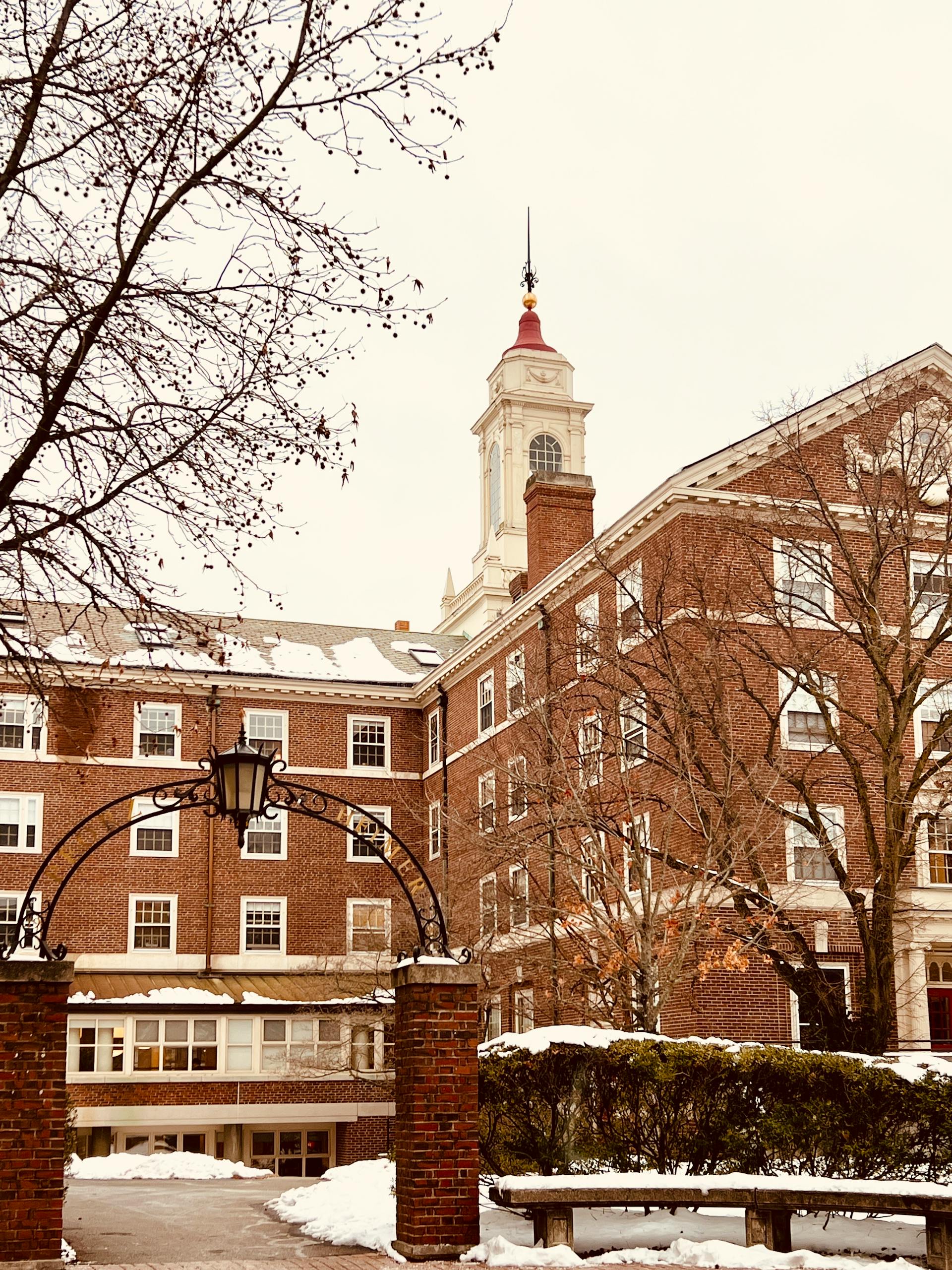 Historic brick building under a snowy sky with winter architecture charm.